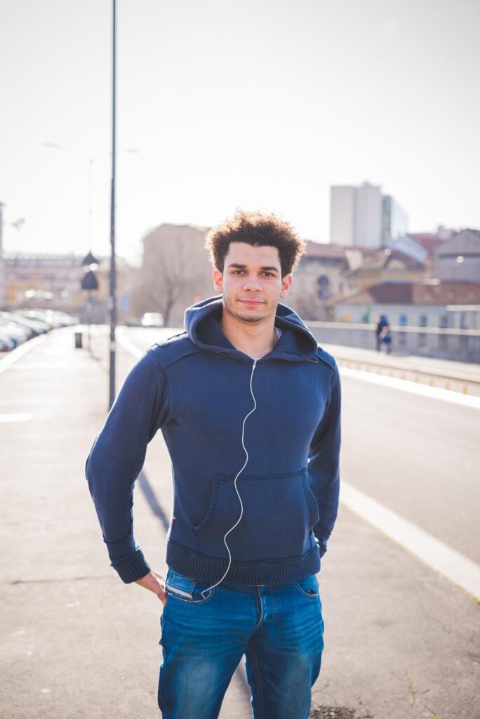 Young man standing in the street and looking camera