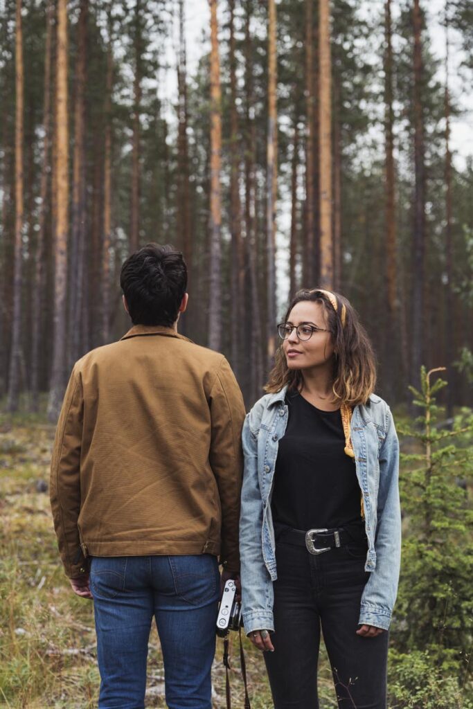 Finland, Lapland, man with camera and woman standing in rural landscape